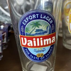 Vailima lager glass with logo and text.