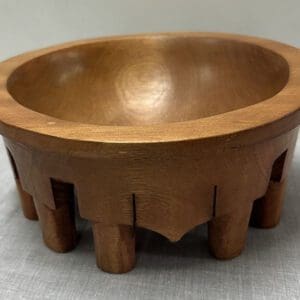 Wooden bowl with carved geometric design.