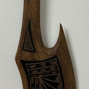 Carved wooden ceremonial axe with rope-wrapped handle