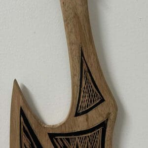 Carved wooden decorative axe with geometric designs