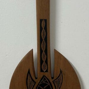 Carved wooden wall paddle with geometric motifs