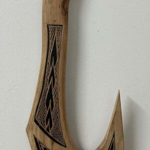 Carved wooden wall hook with geometric designs
