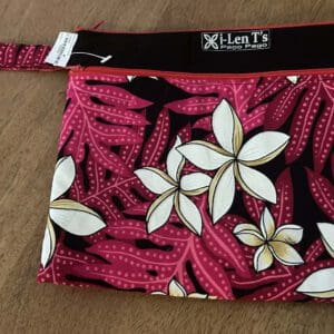 Pink floral fabric wristlet pouch on wood