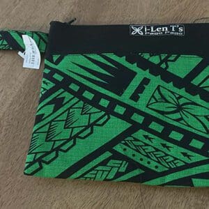 Green and black patterned wristlet pouch on table