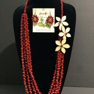 Red beaded necklace with white flower accents