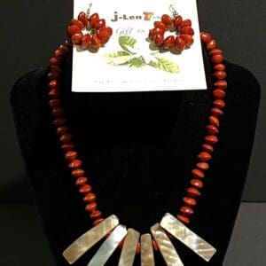 Red bead necklace with mother-of-pearl pendants