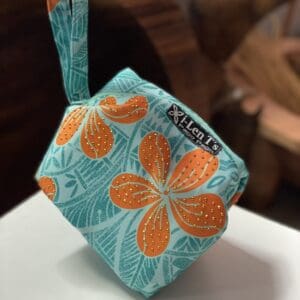Turquoise wristlet pouch with orange hibiscus